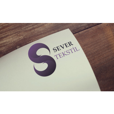 Tekstil firma logosu yarışmasına tasarımcı LiquidSword tarafından sunulan  tasarım 